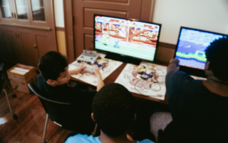 Youth playing retro games at Next Move Arcade Jam